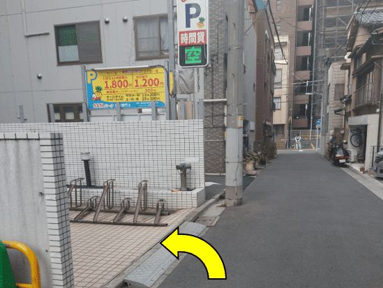 Bicycle parking on the left, arrow pointing left